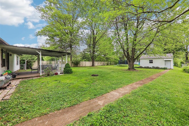 view of yard with fence, a patio area, and a trampoline
