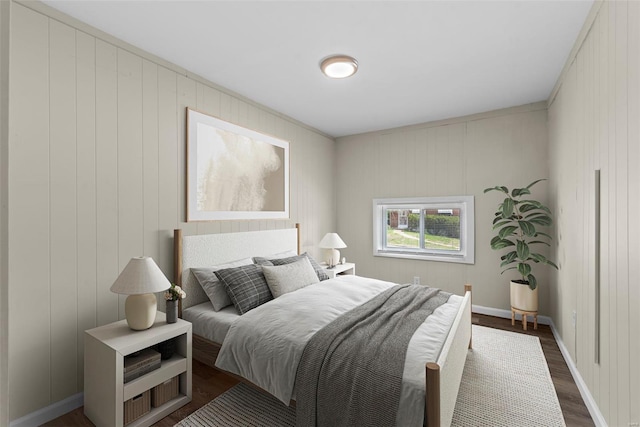 bedroom featuring baseboards and dark wood finished floors