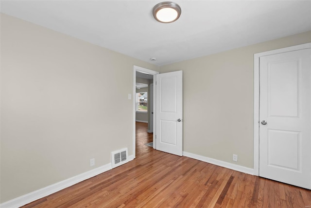 unfurnished bedroom with visible vents, baseboards, and light wood finished floors
