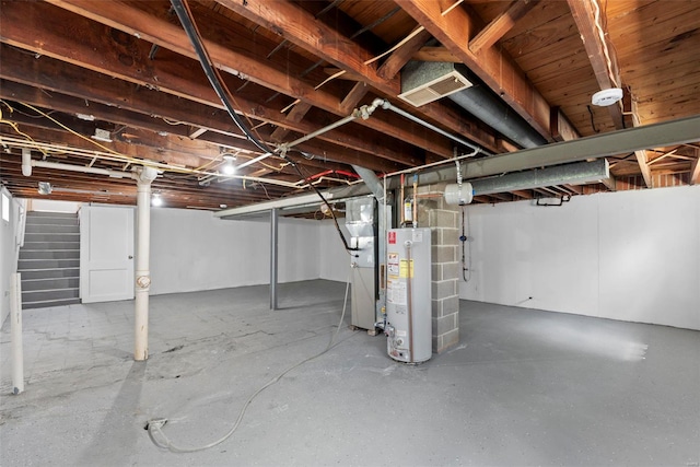 unfinished basement with visible vents, stairway, and gas water heater