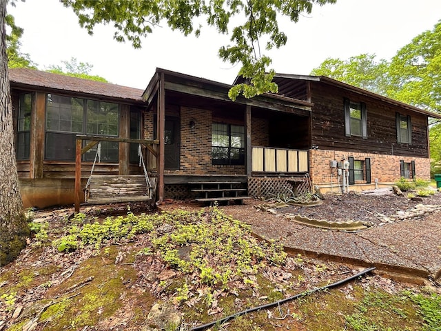 exterior space featuring brick siding and a porch