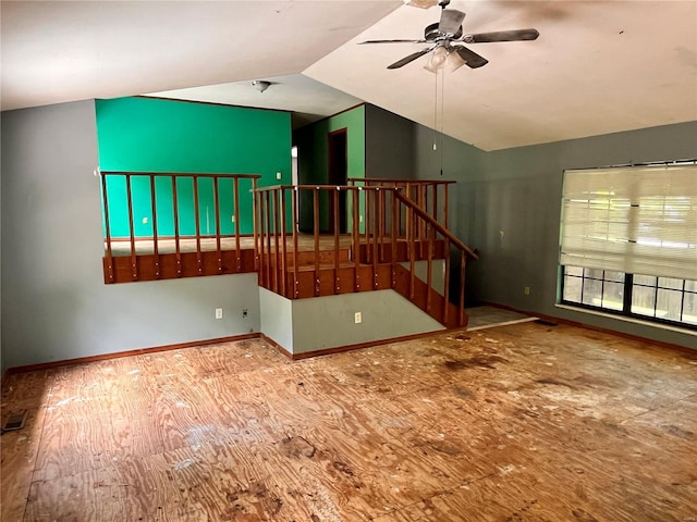 unfurnished living room featuring ceiling fan, baseboards, wood finished floors, lofted ceiling, and visible vents