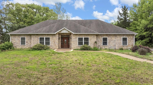 ranch-style home with roof with shingles, stone siding, and a front lawn