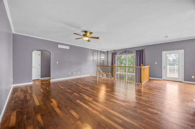 unfurnished living room with visible vents, a ceiling fan, arched walkways, and wood finished floors
