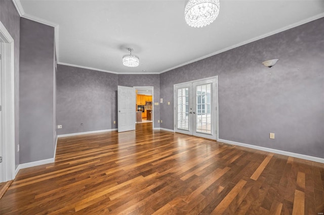 interior space with french doors, ornamental molding, wood finished floors, and an inviting chandelier