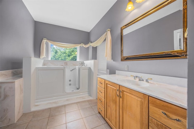 bathroom featuring vanity, tile patterned floors, and a jetted tub