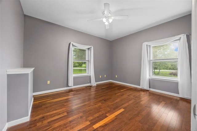 spare room with wood-type flooring, baseboards, and ceiling fan