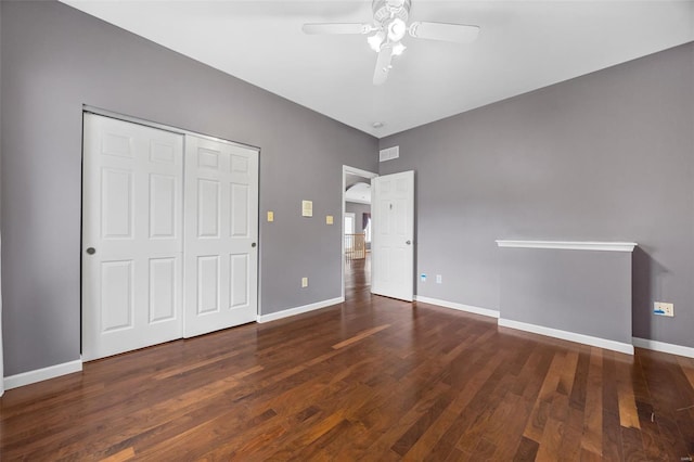 unfurnished bedroom with baseboards, visible vents, wood finished floors, and a closet