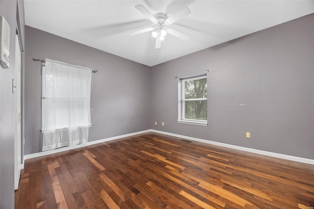 unfurnished room with baseboards, ceiling fan, visible vents, and wood finished floors