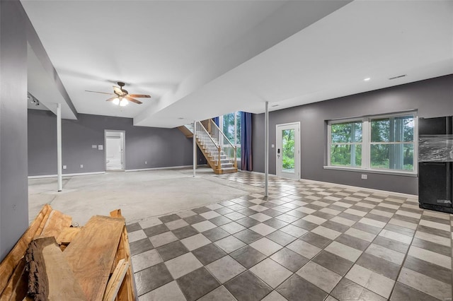 unfurnished living room with baseboards, recessed lighting, ceiling fan, and stairway