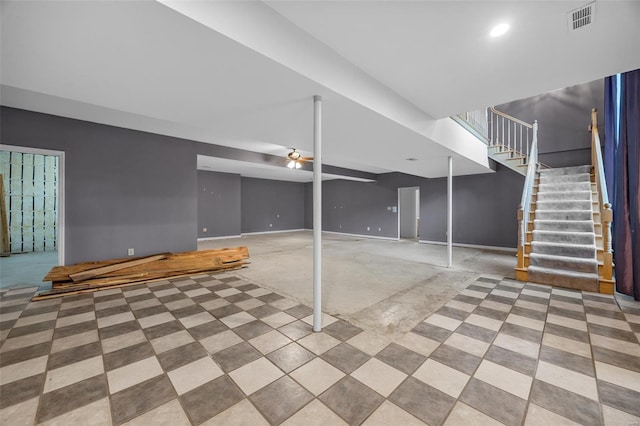 below grade area with baseboards, a ceiling fan, stairs, and visible vents