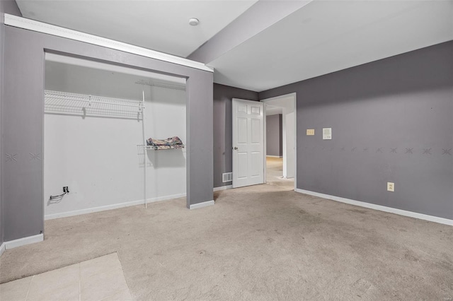 unfurnished bedroom featuring carpet floors, baseboards, visible vents, and a closet