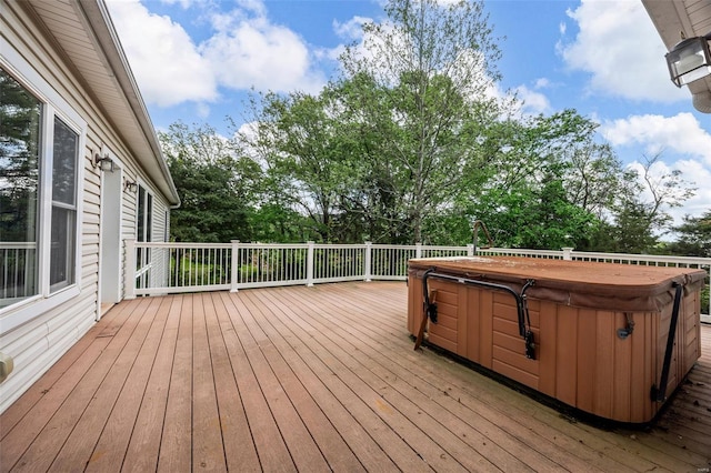wooden deck with a hot tub