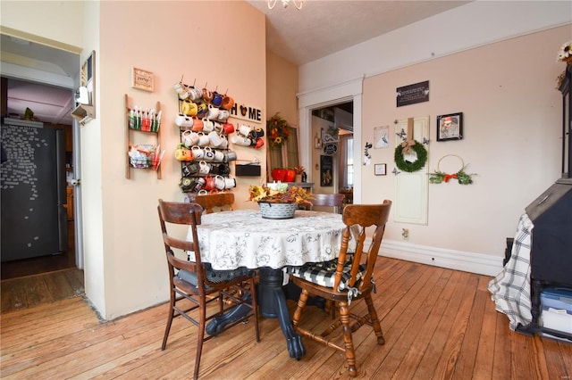 dining room featuring baseboards and light wood finished floors