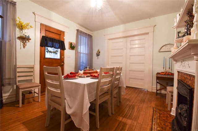 dining area featuring a fireplace and hardwood / wood-style floors