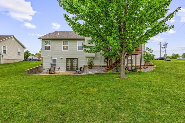 back of property with a yard, french doors, a patio area, stairway, and a wooden deck