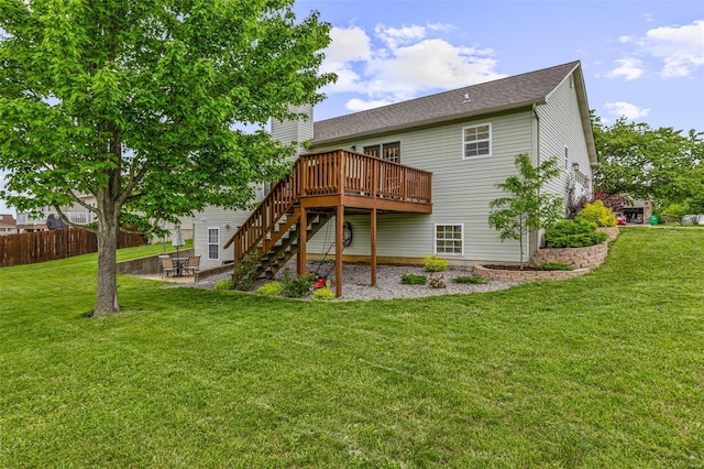 back of house with fence, a wooden deck, a yard, a patio area, and stairs