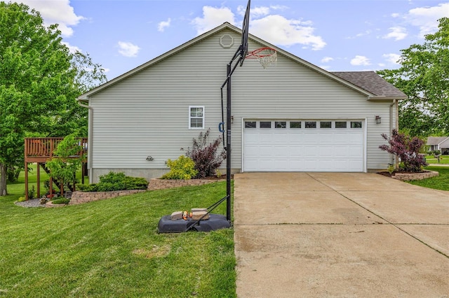 view of home's exterior featuring concrete driveway, a yard, a deck, and a garage