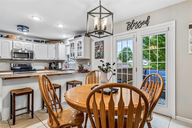 dining room featuring light tile patterned floors, an inviting chandelier, and recessed lighting