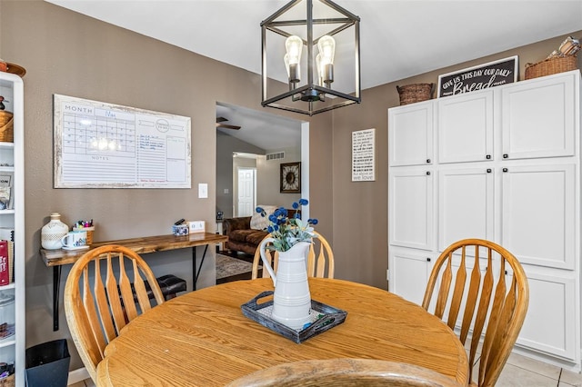 dining area featuring a notable chandelier, light tile patterned floors, and visible vents