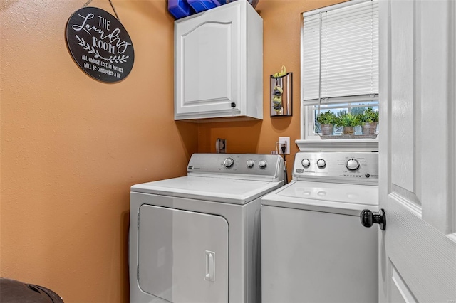 washroom with washer and dryer and cabinet space