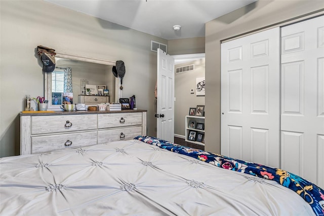 bedroom with a closet, baseboards, and visible vents