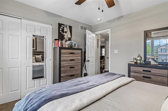 bedroom with ceiling fan, carpet flooring, a closet, and visible vents