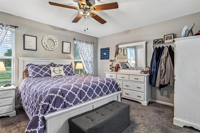 bedroom with baseboards, dark colored carpet, and ceiling fan