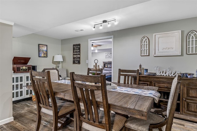 dining space with visible vents, wood finished floors, and ceiling fan