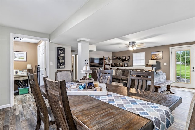 dining space with a ceiling fan, dark wood-style flooring, and baseboards