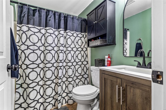 bathroom with toilet, curtained shower, and vanity