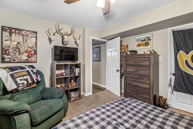 living area with baseboards, ceiling fan, and carpet floors