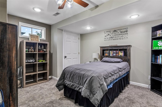 carpeted bedroom with baseboards, a ceiling fan, and visible vents
