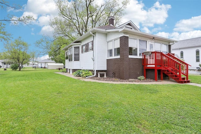 exterior space featuring a chimney and a front lawn