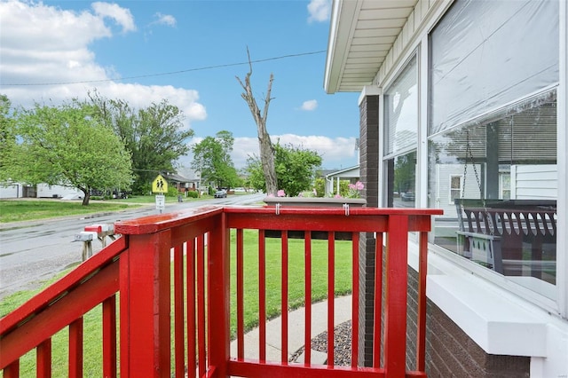 wooden terrace with a yard