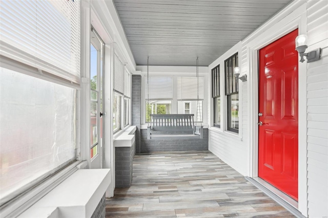unfurnished sunroom featuring wood finished floors