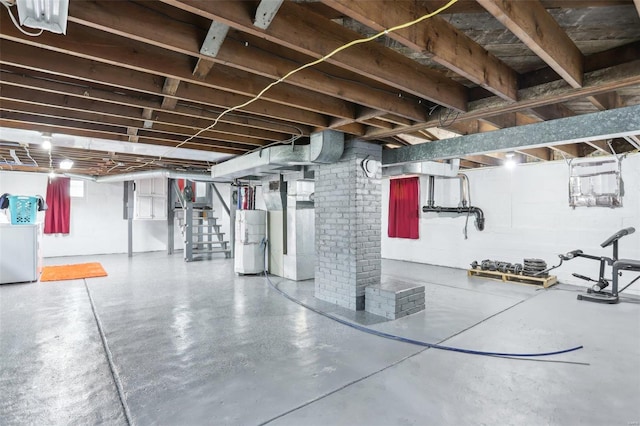 below grade area with washer / dryer, water heater, and stairs