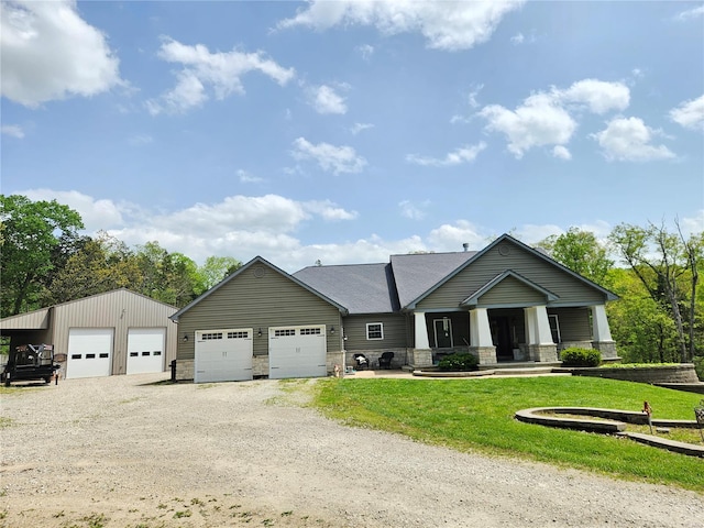 craftsman-style home with a garage, a front lawn, covered porch, stone siding, and dirt driveway