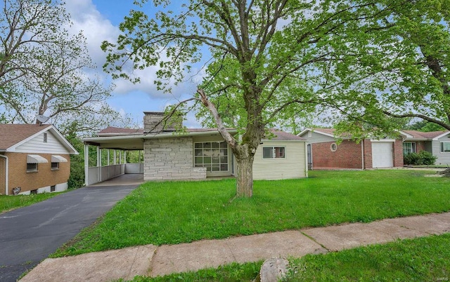 ranch-style home with a front lawn, aphalt driveway, stone siding, and an attached carport