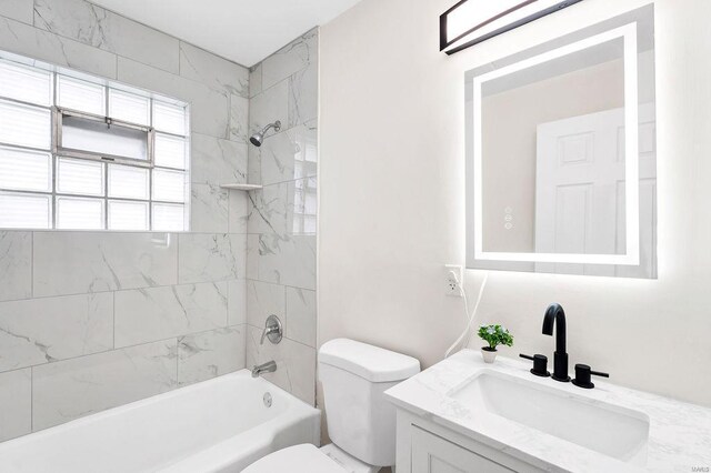 full bath featuring shower / bathtub combination, toilet, and vanity