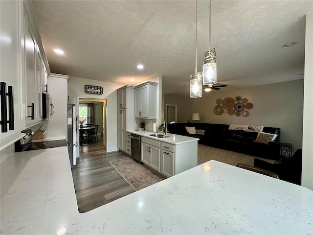 kitchen featuring light countertops, stainless steel appliances, a ceiling fan, and a sink