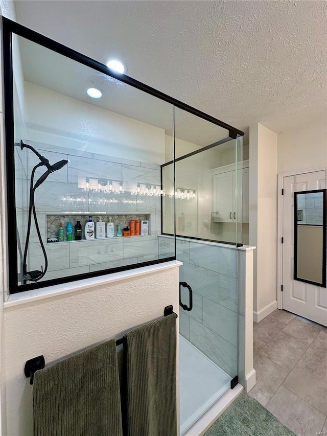 bathroom featuring a stall shower, recessed lighting, a textured ceiling, baseboards, and tile patterned floors