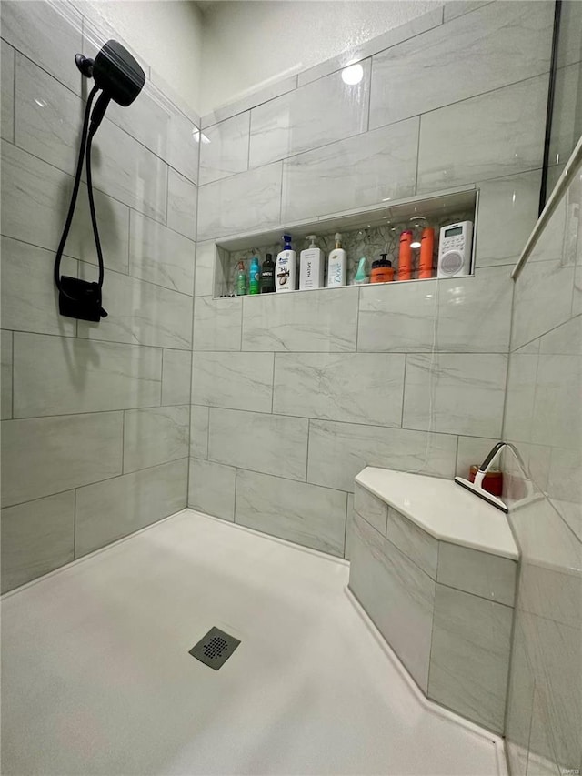 bathroom with a tile shower