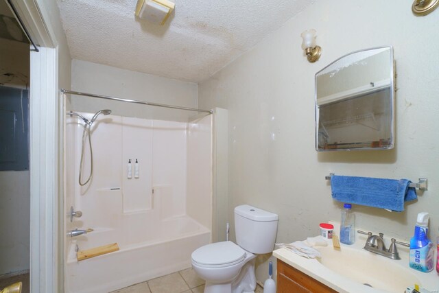 bathroom featuring a textured ceiling, toilet, tile patterned floors, vanity, and shower / bathing tub combination