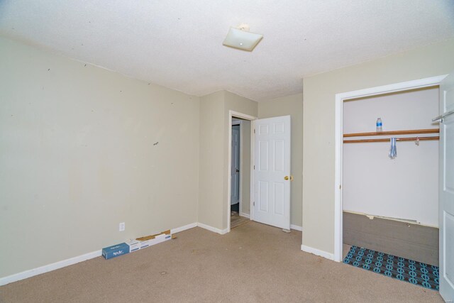 unfurnished bedroom with a closet, baseboards, and carpet floors