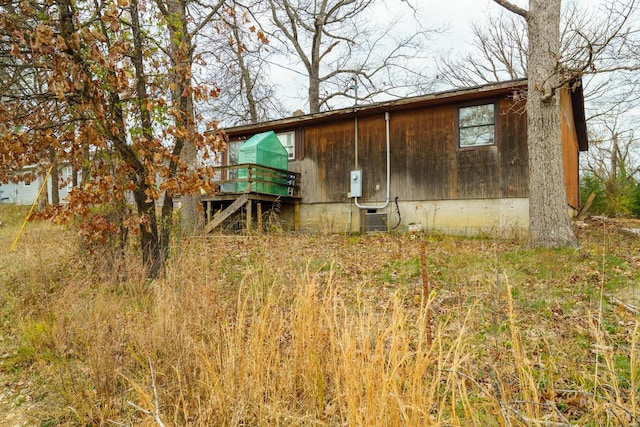 back of house featuring central AC unit, crawl space, and a wooden deck