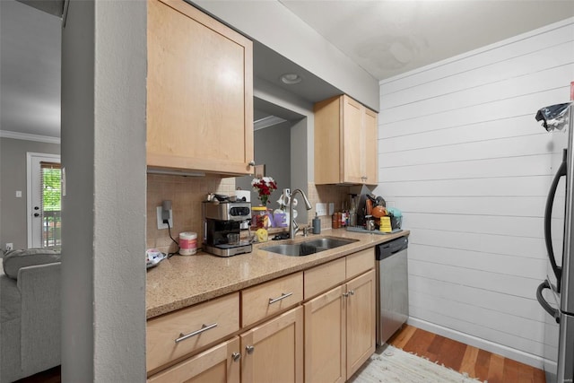 kitchen with crown molding, light brown cabinets, a sink, light wood finished floors, and dishwasher