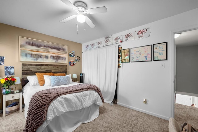 carpeted bedroom featuring baseboards and ceiling fan
