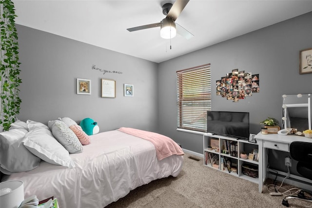 carpeted bedroom featuring visible vents, a ceiling fan, and baseboards