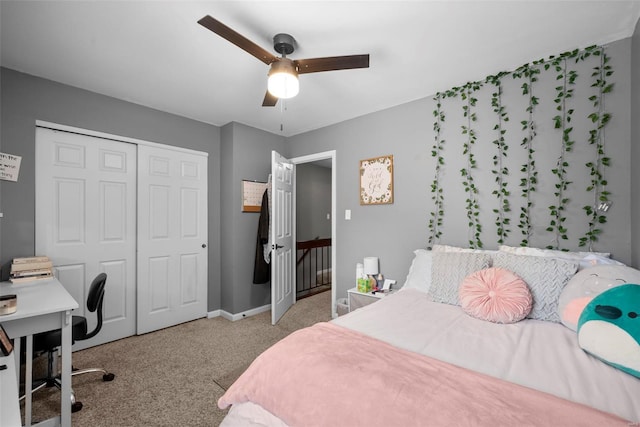 bedroom with a ceiling fan, baseboards, carpet, and a closet